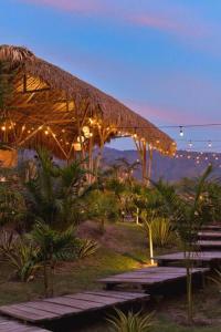 a building with a bunch of benches and lights at finca playa seca in Santa Fe de Antioquia