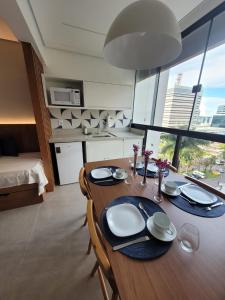 mesa de comedor en una habitación con ventana grande en Garvey Park Hotel - Quarto Premium 409 en Brasilia