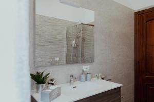 a bathroom with a sink and a mirror at La casa di Grazia in Rome