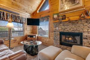 a living room with a fireplace in a log cabin at Snuggle Bear Hideaway in Pigeon Forge