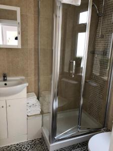 a bathroom with a shower and a sink at Westbourne Terrace in London