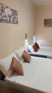 En eller flere senge i et værelse på Dépendance du Glam Resort