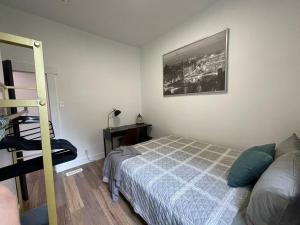 um quarto com uma cama e uma fotografia na parede em Charming Century Apartments, Steps to downtown em London
