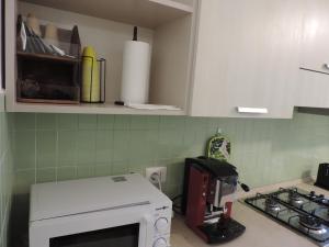 cocina con fogones y microondas blanco en Sciesa Guest House, en Verona