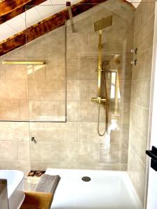 a bathroom with a shower and a bath tub at Gasthof Königstand in Garmisch-Partenkirchen +7 photos