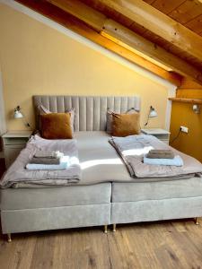 a bedroom with a large bed with two pillows at Gasthof Königstand in Garmisch-Partenkirchen