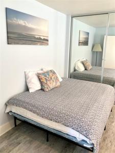 a bedroom with two beds and a mirror at 125-fun In The Sun Penthouse in San Diego