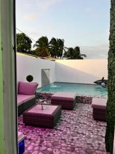 un patio con piscina, mesa y sillas en Satisfaction en San Juan