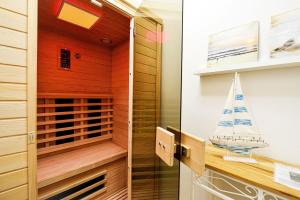 a sauna with a sailboat on the wall at Haus Nordseebrandung NC24 in Cuxhaven +17 photos
