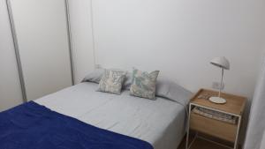 a small bedroom with a bed and a night stand at Marta 3 in Posadas
