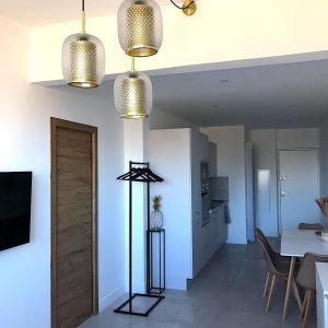 a living room with two lights and a dining room at Superb apartment with sea view, 200m from beach in San-Martino-di-Lota