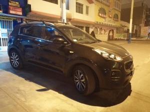 a small blue car parked on a city street at Lopez House in Lima