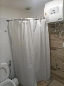 a bathroom with a shower curtain and a toilet at Lavalleja 71 in Mercedes