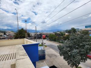 uma vista para uma rua da cidade com um edifício azul em Departamento amplio 2 dormitorios em Cuenca