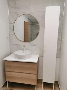 a bathroom with a sink and a mirror at Charmante Maison dans le Vieux Douai in Douai
