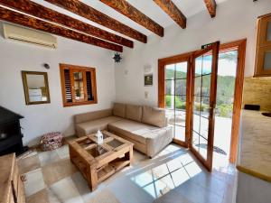 a living room with a couch and a table at Apartamentos Pinosol in Santa Eularia des Riu