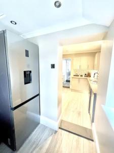 a kitchen with a stainless steel refrigerator in a room at Spacious Modern Victorian House in Rochester in Wainscot