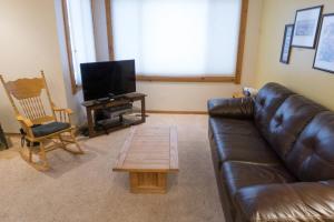 a living room with a leather couch and a coffee table at 4081 Ski Trails in Truckee