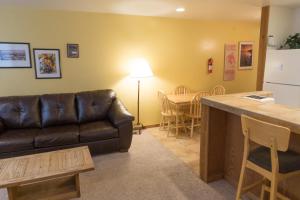 a living room with a leather couch and a table at 4081 Ski Trails in Truckee