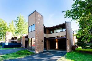 a large brick building with a tree at Park Avenue Upgraded 2 Bedroom Condominiums in Park City