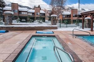 a swimming pool in the snow with a building in the background at Park Avenue Upgraded 2 Bedroom Condominiums in Park City