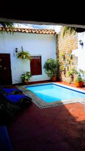 a swimming pool in front of a house with plants at Casa San Francisco Honda in Honda