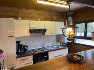 a kitchen with a sink and a stove top oven at Cozy holiday home on a horse farm in the Lüneburg Heath in Eschede