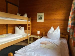 a room with two bunk beds in a cabin at Cozy holiday home on a horse farm in the Lüneburg Heath in Eschede