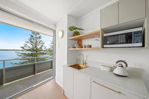 a kitchen with a sink and a large window at The Mid Pacific in Port Macquarie