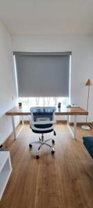 a office with a desk and a chair in a room at VK Loft - Apartamento en Miraflores in Lima