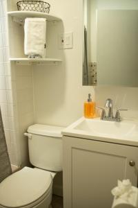 a white bathroom with a toilet and a sink at Cozy Getaway in Everett
