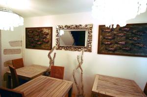 a dining room with two tables and a mirror on the wall at Boutique Hotel Placa in Krk