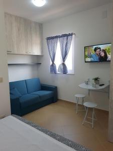 een woonkamer met een blauwe bank en een tafel bij Apartments by the sea Pakostane, Biograd - 16203 in Pakoštane