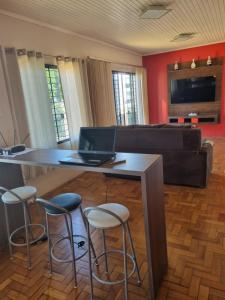 - un salon avec une table et un ordinateur portable dans l'établissement CASA DO PINHEIRO, à Chapecó