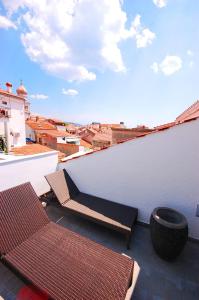 a balcony with two chairs and a table on a building at Boutique Hotel Placa in Krk