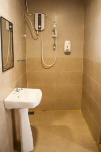 a bathroom with a sink and a shower at The Barat Perhentian in Perhentian Island