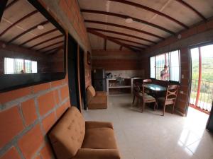 a living room with a couch and a table and chairs at VILLA ISABELLA in Curití