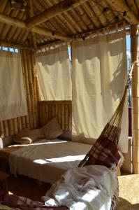 a hammock in a room with a bed and curtains at Casa CORAZON DE LEÓN AQP in Arequipa