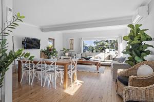 a living room with a table and chairs at Soul Beach House - Belle Escapes Jervis Bay in Vincentia