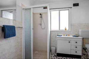 a bathroom with a shower and a sink at Salt Life - Belle Escapes Jervis Bay in Vincentia +26 photos