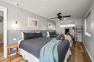 a bedroom with two beds and a ceiling fan at Salt Life - Belle Escapes Jervis Bay in Vincentia