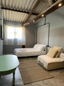a bedroom with two beds and a table and a mirror at Casa da Rota in São Roque
