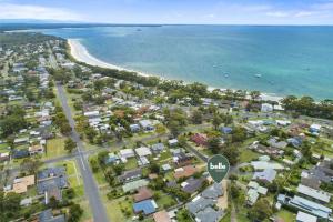 an aerial view of a beach with houses at Villa Serene - Belle Escapes Jervis Bay in Vincentia +12 photos
