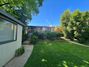 a yard with a house in the background at Magnolia on Toorak in Bright