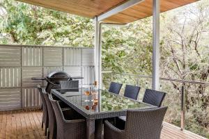 an outdoor table and chairs on a deck at Melaleuca in Dunsborough