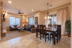a dining room and living room with a table and chairs at D5-Coral Springs Poolside-Ground Floor 3-bedroom Hillside View in Hurricane