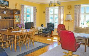 a living room with a table and chairs at Amazing Home In Olden With 4 Bedrooms And Wifi in Olden