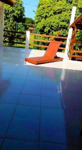 an orange chair sitting on top of a patio at Pousada da Adélia in Itaúnas +26 photos