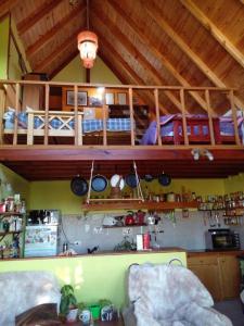 a room with a kitchen with a loft at Casa de Lago y Montaña in El Calafate