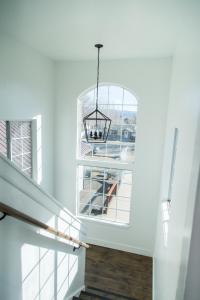 a hallway with a large window and a chandelier at Happy Trails BnB in Tropic